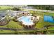 Aerial view of community pool, clubhouse, tennis court, and playground at 11288 Listening Dr, Orlando, FL 32832