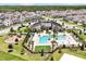 Aerial view of a community clubhouse with swimming pool and playground at 11288 Listening Dr, Orlando, FL 32832