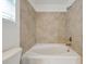 Clean bathroom featuring a white tiled tub and bronze fixtures at 11288 Listening Dr, Orlando, FL 32832