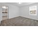 Spacious bedroom featuring neutral carpet, natural light, and an ensuite bathroom at 11288 Listening Dr, Orlando, FL 32832