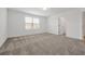 Spacious bedroom with plush carpet, window views, and ensuite bathroom access at 11288 Listening Dr, Orlando, FL 32832