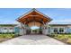 Inviting clubhouse entrance with stone columns and manicured landscaping at 11288 Listening Dr, Orlando, FL 32832