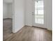 Bright entryway with wood-look tile flooring, leading to a carpeted room and a stylish front door at 11288 Listening Dr, Orlando, FL 32832