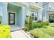 Inviting front entrance with a covered porch, manicured landscaping, and a welcoming facade at 11288 Listening Dr, Orlando, FL 32832
