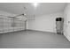 Spacious garage with garage door, water heater, and painted walls at 11288 Listening Dr, Orlando, FL 32832