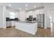 Bright, modern kitchen featuring white cabinetry, stainless steel appliances, and a center island at 11288 Listening Dr, Orlando, FL 32832