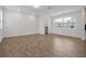 Bright living room with wood-look floors, recessed lighting, and large windows filling the space with natural light at 11288 Listening Dr, Orlando, FL 32832