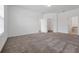 Spacious bedroom with neutral carpet, walk-in closet, bright windows, and ensuite bathroom at 11288 Listening Dr, Orlando, FL 32832