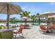 Community pool area featuring patio seating, palm trees, and a splash pad, perfect for relaxation and Gathering fun at 11288 Listening Dr, Orlando, FL 32832