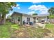 Spacious backyard with patio, seating area, and lush green grass, perfect for entertaining and relaxation at 1210 Quintuplet Dr, Casselberry, FL 32707