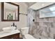 Modern bathroom with a vessel sink, a sleek vanity, and a beautifully tiled walk-in shower, showcasing contemporary design at 1210 Quintuplet Dr, Casselberry, FL 32707