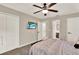 Comfortable bedroom featuring a ceiling fan, carpeted floor, and a wall-mounted television, perfect for relaxation at 1210 Quintuplet Dr, Casselberry, FL 32707