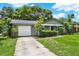 Charming one-story home with a lush green lawn and concrete driveway leading to the garage at 1210 Quintuplet Dr, Casselberry, FL 32707