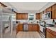 Modern kitchen with stainless steel appliances, granite countertops, and light brown cabinetry at 1210 Quintuplet Dr, Casselberry, FL 32707
