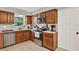 Functional kitchen features wooden cabinets and stainless steel appliances at 1210 Quintuplet Dr, Casselberry, FL 32707