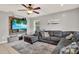 Cozy living room featuring a large sectional sofa, ceiling fan, and mounted TV for relaxing at 1210 Quintuplet Dr, Casselberry, FL 32707