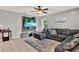 Cozy living room featuring a large sectional sofa, ceiling fan, and mounted TV for relaxing at 1210 Quintuplet Dr, Casselberry, FL 32707