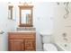 Well-lit bathroom features granite countertop, wood vanity, and tub at 123 Edgewater Cir, Sanford, FL 32773