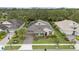 Stunning aerial view of a well-maintained home showcasing lush landscaping, a stone facade, and a tile roof in a vibrant community at 1265 Estancia Woods Loop, Windermere, FL 34786