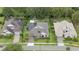 Overhead view of well-manicured properties, featuring solar panels, lush lawns and mature trees at 1265 Estancia Woods Loop, Windermere, FL 34786
