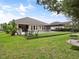 Lush backyard with pool, pergola, mature trees, and ample space for outdoor enjoyment at 1265 Estancia Woods Loop, Windermere, FL 34786