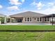 Beautiful backyard with a pool, artificial turf and covered patio for relaxing and entertaining at 1265 Estancia Woods Loop, Windermere, FL 34786