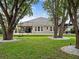 Large backyard with artificial turf, a play area, mature trees and plenty of space for activities at 1265 Estancia Woods Loop, Windermere, FL 34786