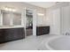 Luxurious primary bathroom featuring dual vanities, soaking tub, and walk-in shower at 1265 Estancia Woods Loop, Windermere, FL 34786