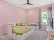 Bright bedroom with pink walls, a ceiling fan, carpeted floor, and a white bed with built-in drawers at 1265 Estancia Woods Loop, Windermere, FL 34786