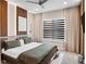 Modern bedroom with decorative wood paneling, plush carpeting, and neutral-toned decor at 1265 Estancia Woods Loop, Windermere, FL 34786