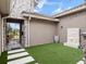 Private courtyard with artificial turf, stone accents, wrought iron gate and Zen garden elements at 1265 Estancia Woods Loop, Windermere, FL 34786