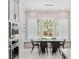 Bright dining area featuring a modern light fixture, tile floors, and views of the backyard at 1265 Estancia Woods Loop, Windermere, FL 34786
