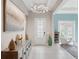Inviting foyer featuring tiled flooring, a modern chandelier, decorative artwork, and an open doorway to the living area at 1265 Estancia Woods Loop, Windermere, FL 34786