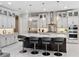 Modern kitchen featuring a large island with seating, stainless steel appliances, elegant pendant lighting, and ample cabinet space at 1265 Estancia Woods Loop, Windermere, FL 34786