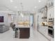 Bright kitchen with a central island, modern appliances, and a seamless transition to the living area for effortless entertaining at 1265 Estancia Woods Loop, Windermere, FL 34786