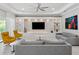 Spacious living room features a decorative wall unit with shelving, recessed lighting, and modern decor at 1265 Estancia Woods Loop, Windermere, FL 34786