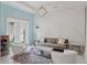 Elegant living room featuring a decorative accent wall, stylish furniture, a modern lighting fixture, and sliding glass doors at 1265 Estancia Woods Loop, Windermere, FL 34786