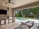 Enjoy the backyard pool view from this outdoor kitchen and living space at 1265 Estancia Woods Loop, Windermere, FL 34786