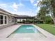 Beautiful backyard pool with lush landscaping, perfect for relaxation and entertainment at 1265 Estancia Woods Loop, Windermere, FL 34786