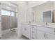 Modern bathroom featuring double vanity with large mirror, walk-in shower and private toilet at 1267 Stockwell Ave, St Cloud, FL 34771
