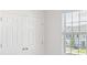 This bedroom features natural light from a window and a closet with double doors at 1267 Stockwell Ave, St Cloud, FL 34771