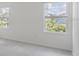 Bright bedroom with neutral carpet and two large windows at 1267 Stockwell Ave, St Cloud, FL 34771