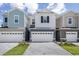 Three-story townhouses feature individual two-car garages and manicured landscaping at 1267 Stockwell Ave, St Cloud, FL 34771