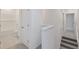 Bright upstairs hallway featuring gray carpet with a bathroom and bedroom nearby at 1267 Stockwell Ave, St Cloud, FL 34771