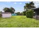 Expansive backyard with lush greenery, storage shed, and partial views of neighboring homes at 137 W Lauren Ct, Fern Park, FL 32730