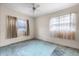 This cozy bedroom features a ceiling fan and two windows at 137 W Lauren Ct, Fern Park, FL 32730