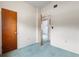 Bedroom with blue carpet, neutral walls, and a view into the hallway at 137 W Lauren Ct, Fern Park, FL 32730