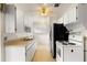 Bright kitchen with modern black refrigerator and white appliances at 137 W Lauren Ct, Fern Park, FL 32730
