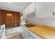 Kitchen with stainless steel sink, wood panel, and white cabinetry at 137 W Lauren Ct, Fern Park, FL 32730