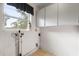 The functional laundry room features white cabinets and a window at 137 W Lauren Ct, Fern Park, FL 32730
